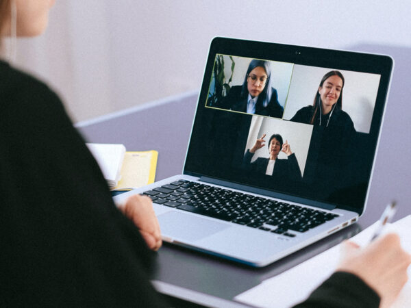 Image of a virtual courtroom or mediation session taking place on a laptop..
